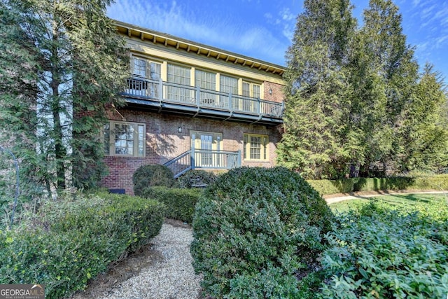 rear view of property featuring a balcony