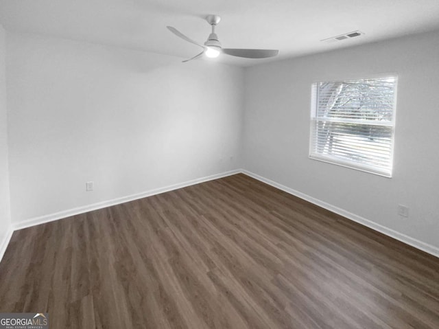 unfurnished room with ceiling fan and dark hardwood / wood-style floors