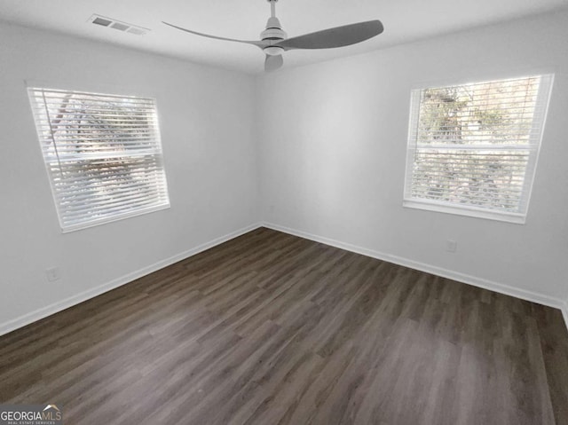 unfurnished room featuring ceiling fan and dark hardwood / wood-style flooring