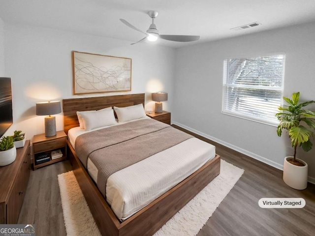 bedroom with ceiling fan and dark hardwood / wood-style flooring