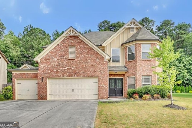 view of front of house with a front yard and a garage