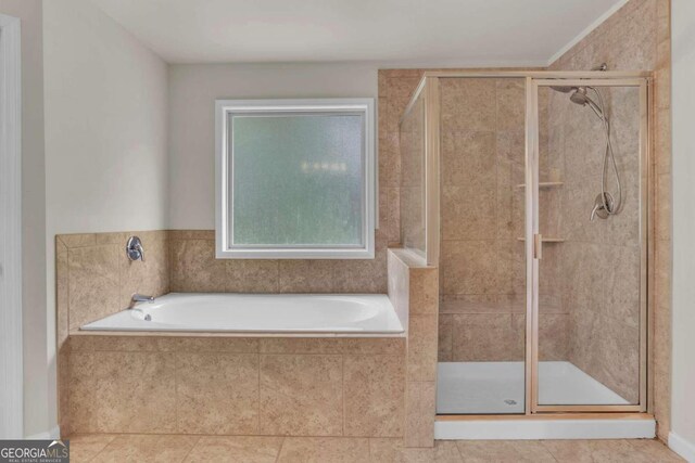 bathroom with separate shower and tub and tile patterned floors