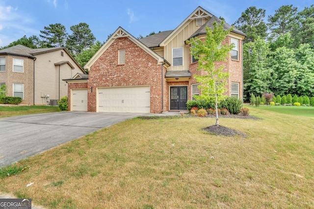view of front of property with central air condition unit, a front yard, and a garage