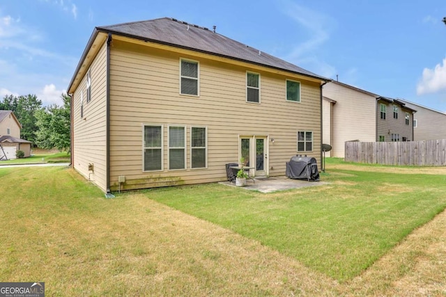 back of house with a patio and a yard