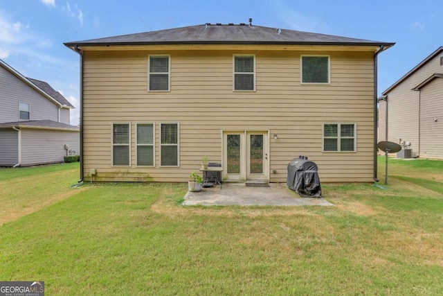 rear view of property featuring central AC, a yard, and a patio
