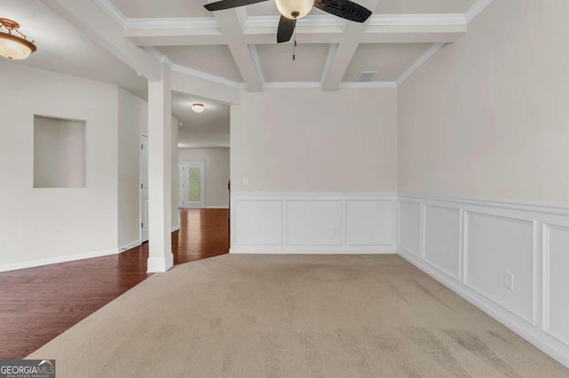 carpeted empty room with crown molding, coffered ceiling, and beam ceiling