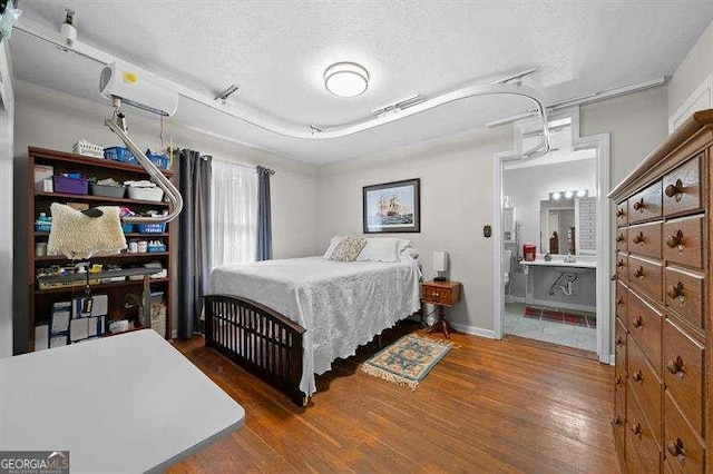 bedroom featuring dark wood-type flooring and a textured ceiling