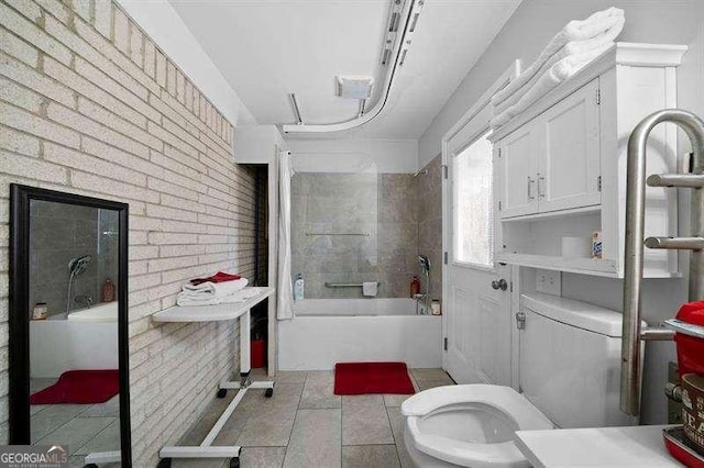 bathroom with  shower combination, toilet, brick wall, and tile patterned flooring