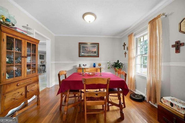 dining room with ornamental molding and dark hardwood / wood-style floors