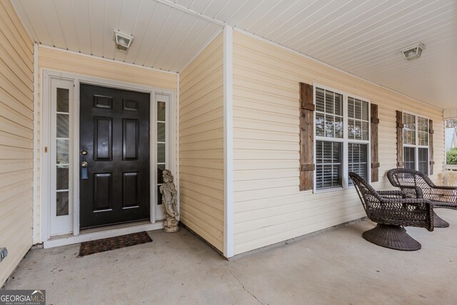 ranch-style home with a garage, a front lawn, and a porch