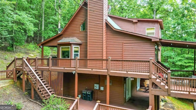 back of house featuring a wooden deck