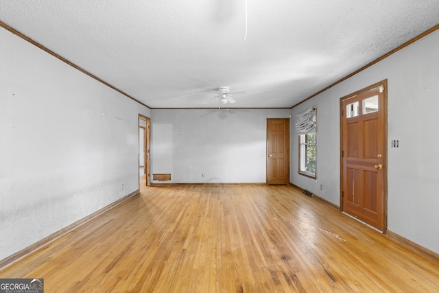 entryway with ornamental molding, ceiling fan, light hardwood / wood-style flooring, and a textured ceiling