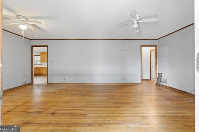 empty room with crown molding, light wood-type flooring, and ceiling fan