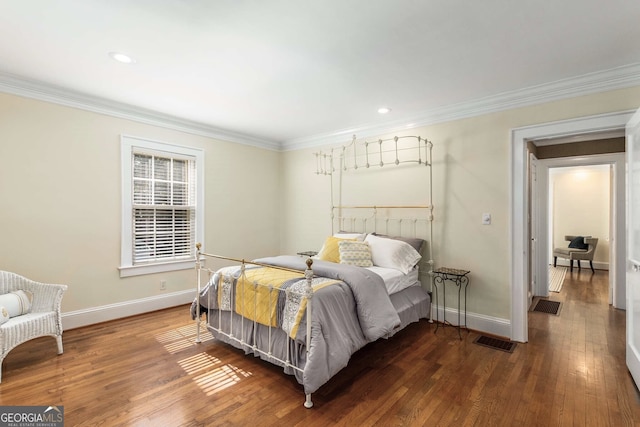 bedroom with dark wood-type flooring and ornamental molding