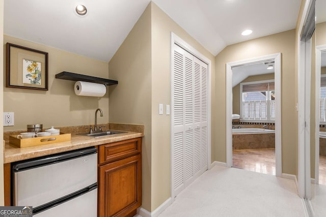 interior space featuring sink, light colored carpet, and dishwasher