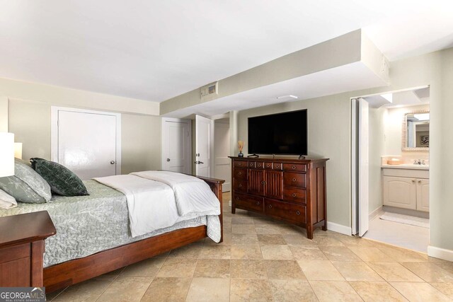 bedroom featuring sink and connected bathroom