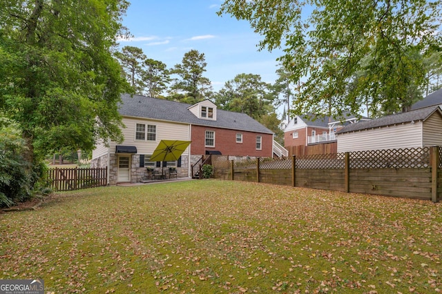 rear view of house with a lawn