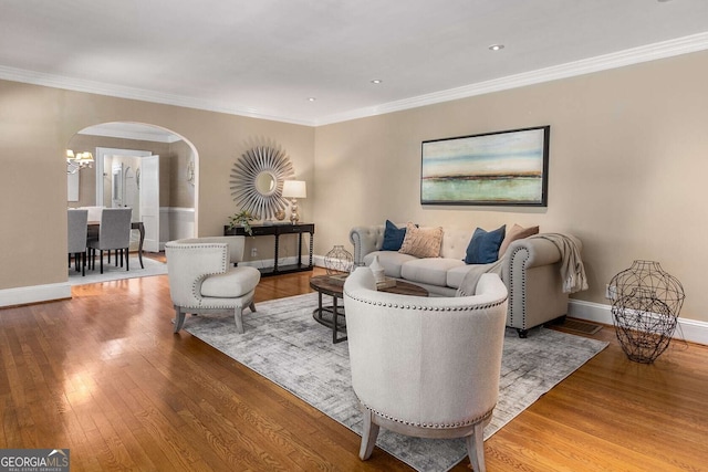 living room featuring wood-type flooring and crown molding