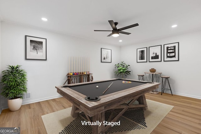 game room with light wood-type flooring, ceiling fan, ornamental molding, and pool table