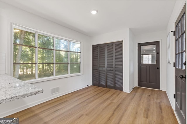 entryway featuring a wealth of natural light and light hardwood / wood-style flooring