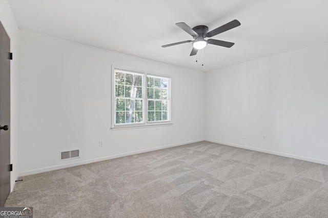 unfurnished room featuring ceiling fan and light carpet