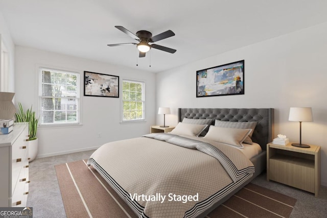 bedroom featuring ceiling fan and light carpet