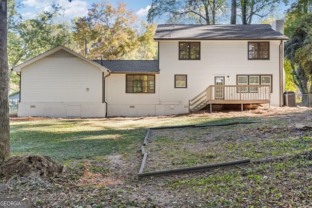 rear view of house with central AC unit, a yard, and a deck