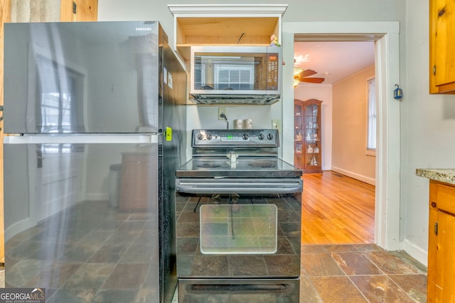 kitchen featuring ceiling fan and stainless steel appliances