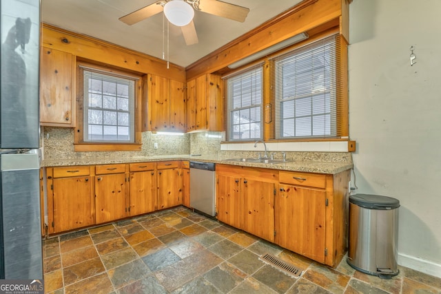 kitchen featuring ceiling fan, sink, backsplash, and stainless steel appliances