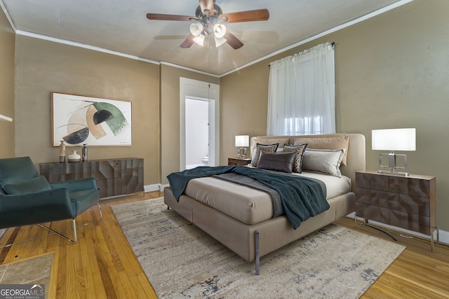 bedroom featuring ceiling fan, ornamental molding, and hardwood / wood-style flooring