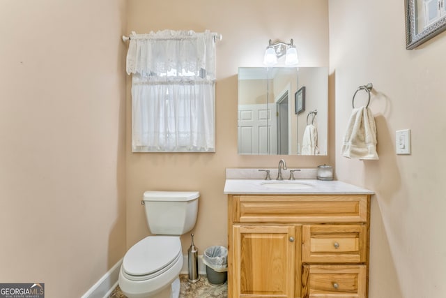 bathroom featuring toilet and vanity