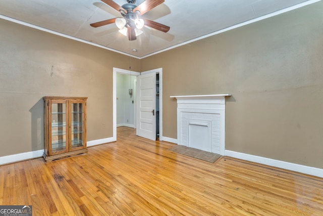 unfurnished living room featuring ceiling fan, light hardwood / wood-style flooring, ornamental molding, and a fireplace