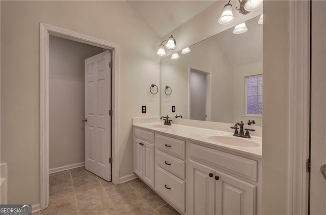 bathroom featuring vanity and vaulted ceiling