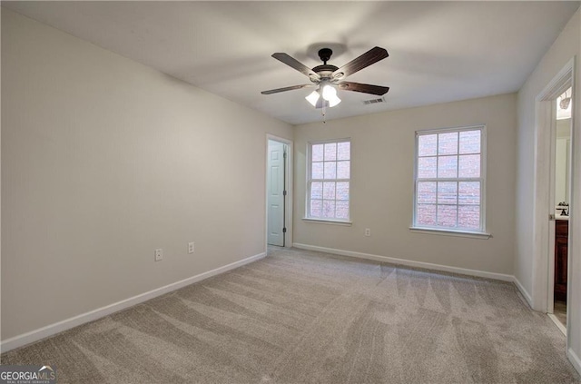 unfurnished room featuring light colored carpet and ceiling fan