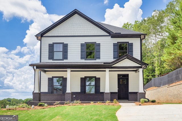 craftsman-style home featuring a porch and a front yard