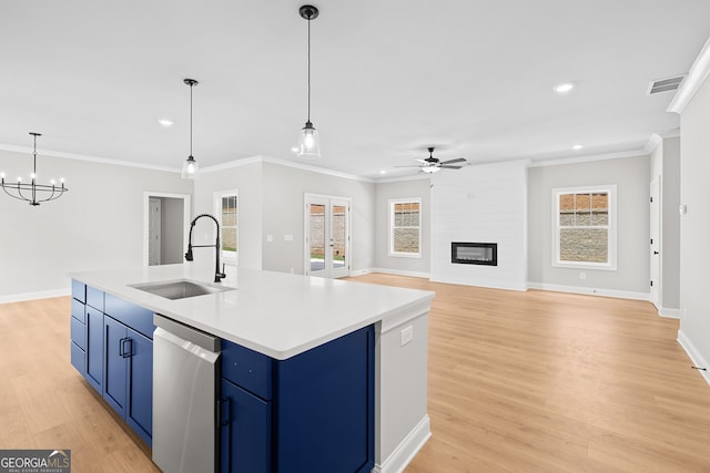 kitchen featuring stainless steel dishwasher, sink, an island with sink, and a wealth of natural light