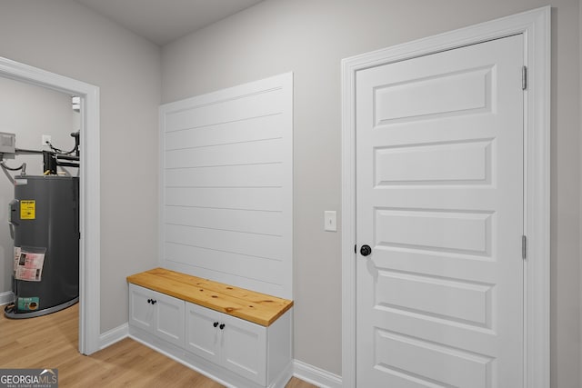 mudroom featuring electric water heater and light wood-type flooring