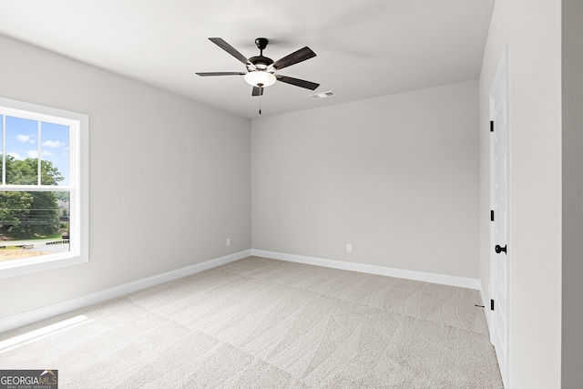 carpeted empty room featuring ceiling fan