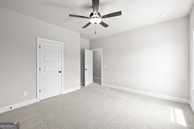 unfurnished bedroom featuring light carpet and ceiling fan