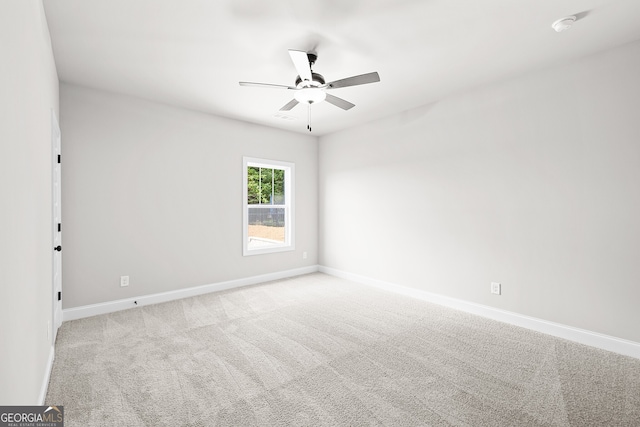 spare room with light carpet and ceiling fan