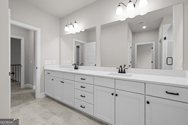 bathroom featuring vanity and a shower with door