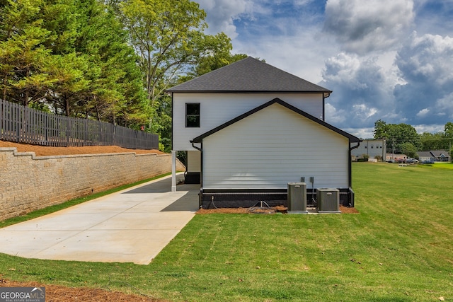 view of home's exterior featuring a yard and central AC unit