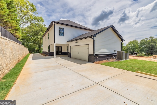 view of home's exterior featuring a garage and a lawn