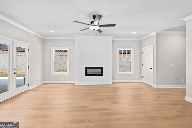 unfurnished living room with a fireplace, ornamental molding, and light hardwood / wood-style floors