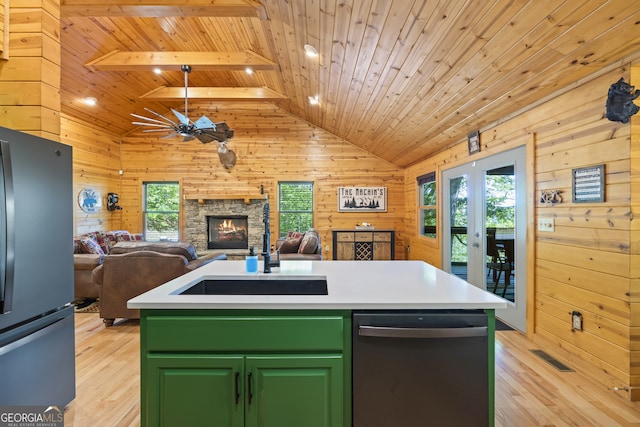 kitchen featuring a center island with sink, black appliances, wooden walls, and wooden ceiling