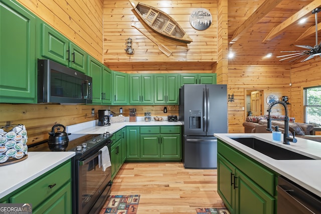 kitchen featuring stainless steel refrigerator with ice dispenser, electric range, wood walls, and green cabinetry