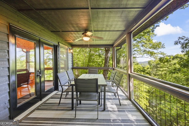 unfurnished sunroom with ceiling fan and wood ceiling