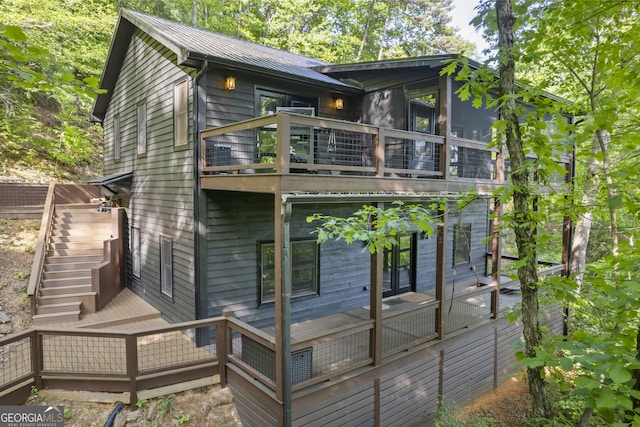 back of house featuring a deck