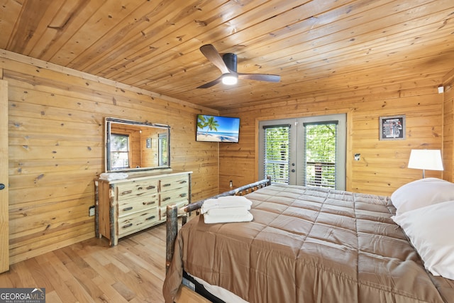 bedroom featuring light hardwood / wood-style floors, wooden ceiling, wooden walls, french doors, and access to outside