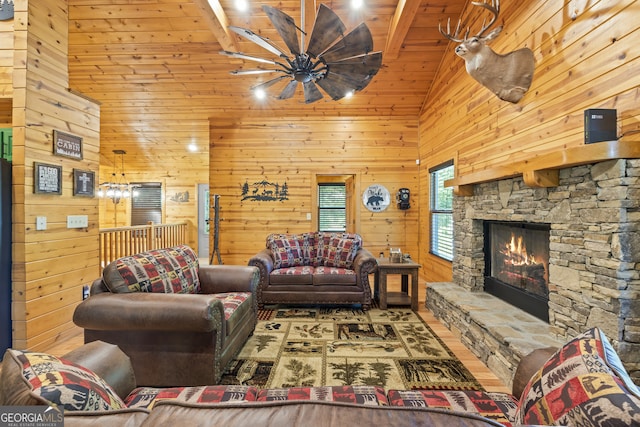 living room featuring a fireplace, wooden walls, beam ceiling, and wood ceiling